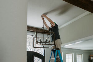 Electrician hanging lighting