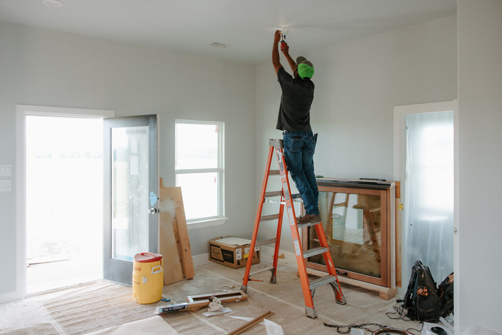 Electrician working on lighting