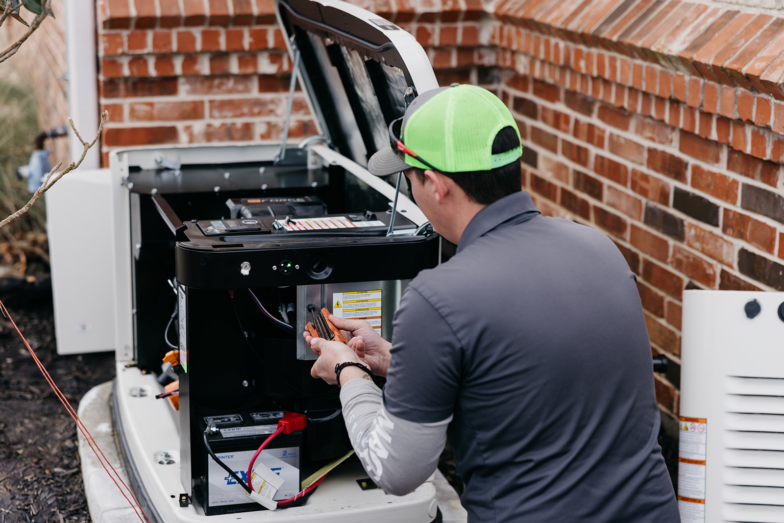 Top Notch technician servicing residential Generac generator in Sherman