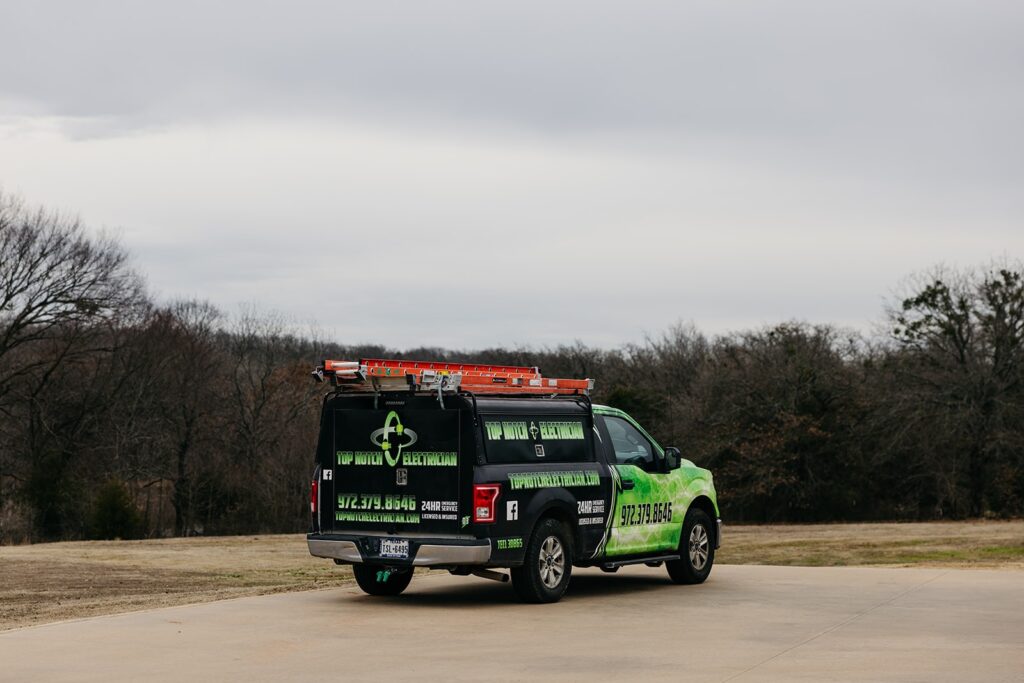 Top Notch Electrician service truck with bright green branding and ladder rack parked on a driveway in Whitesboro, Texas.